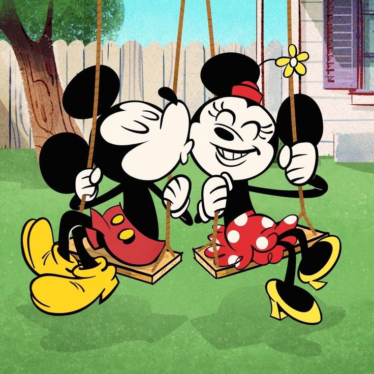 mickey and minnie kissing on swings in front of a house with a tree behind them