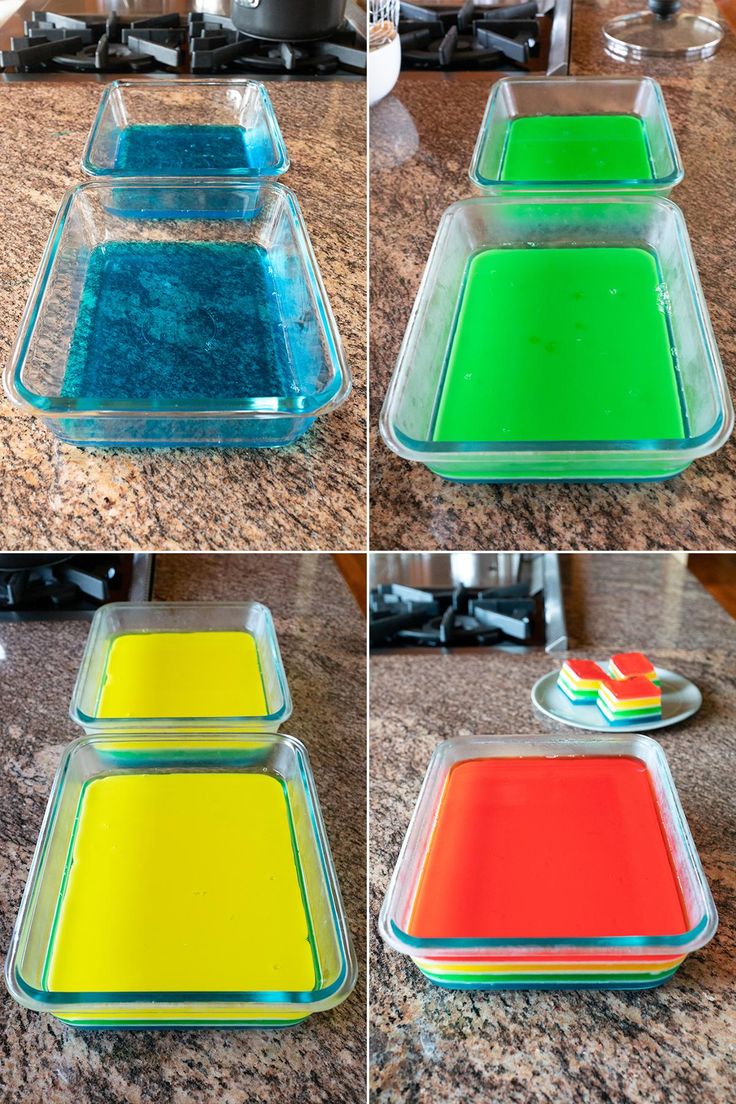 four different colored trays sitting on top of a counter next to a stovetop