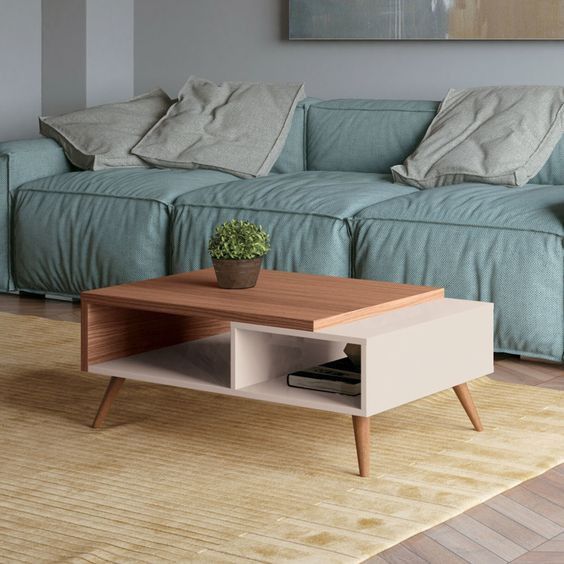 a living room with a blue couch and coffee table