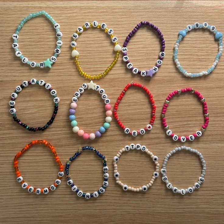 six different bracelets with beads and letters on them