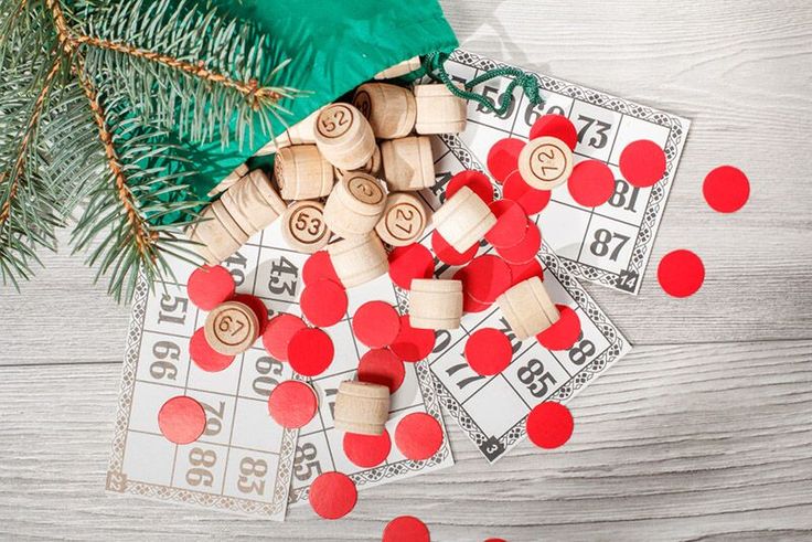 some wooden pegs are laying on top of each other next to a christmas tree