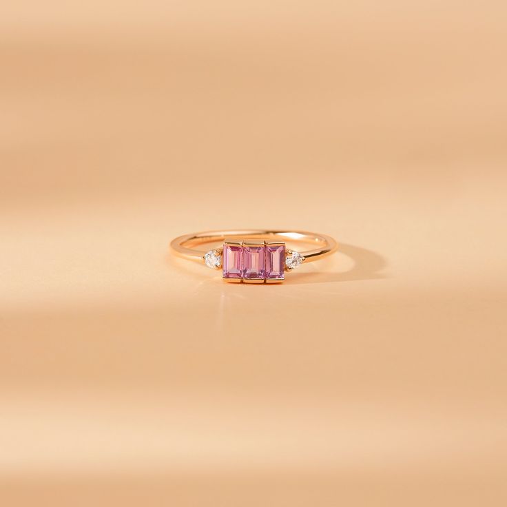 Caresha Everything looks better in pink. The sapphire stone is associated with royalty and is believed to attract abundance, blessings, and gifts. The sapphire gems on this ring have a bezel cut for a simple yet elegant look. Available in Yellow Gold, White Gold, and Rose Gold. - Handmade- Solid Gold - Natural Diamonds and Pink Sapphire- G Color, SI Quality Diamonds- Total Sapphire Carat Weight: 0.45 ctw- Total Diamond Carat Weight: 0.06 ctw- Setting Height: 2.8 mm- Band Size: 1.45 mm All pieces Pink Sapphire Ring Fine Jewelry, Fine Jewelry Pink Sapphire Birthstone Ring For Wedding, Pink Sapphire Birthstone Ring For Weddings, Fine Jewelry Pink Sapphire Ring, Pink Sapphire Yellow Gold Promise Jewelry, Yellow Gold Pink Sapphire Promise Jewelry, Pink Sapphire Ring Birthstone Fine Jewelry, Fine Jewelry Pink Sapphire Diamond Ring In Pink Gold, Fine Jewelry Emerald Cut Pink Sapphire Ring