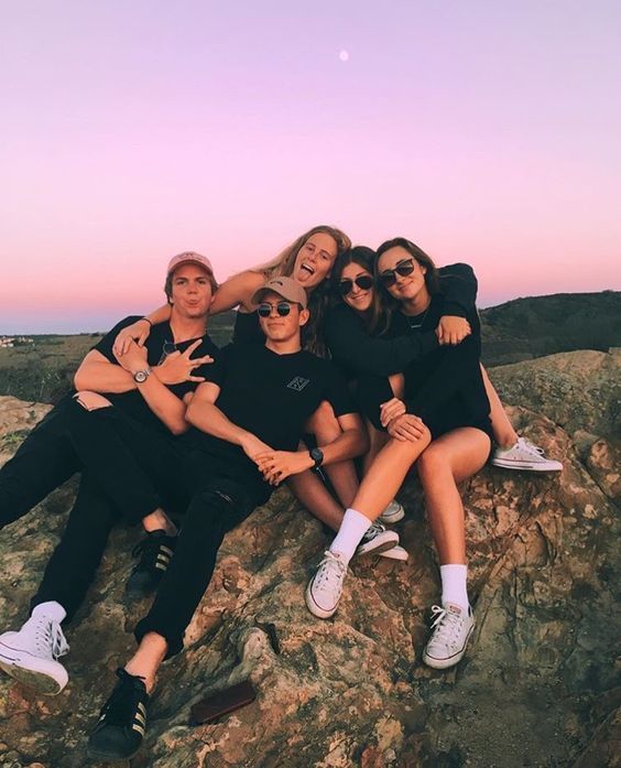 a group of people sitting on top of a rocky hill with the caption real friends who doesn't explore