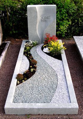 a stone monument with flowers in the middle