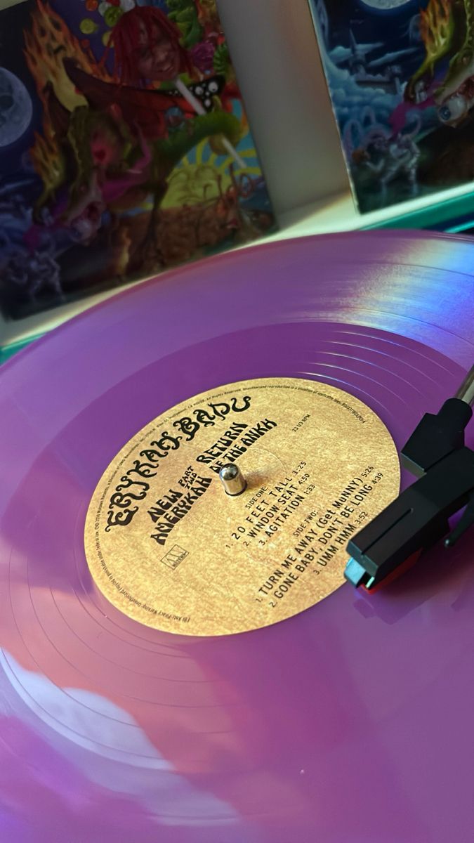 a purple record with a black handle on it