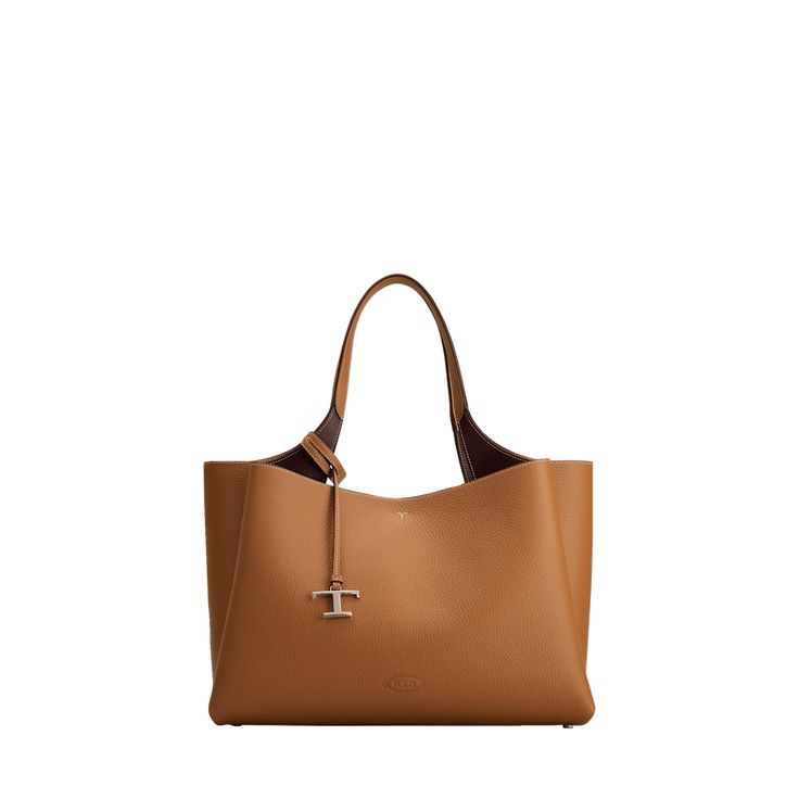 Tod's "Apa" tote bag in leather  Flat shoulder strap with logo charm  Open top with lobster clasp closure  Interior, two zip compartments  Approx. 10.2"H x 16.1"W x 7.4"D Made in Italy Open Top, Leather Tote Bag, Leather Tote, Lobster Clasp, Tops Designs, Shoulder Strap, In Italy, Tote Bag, Italy