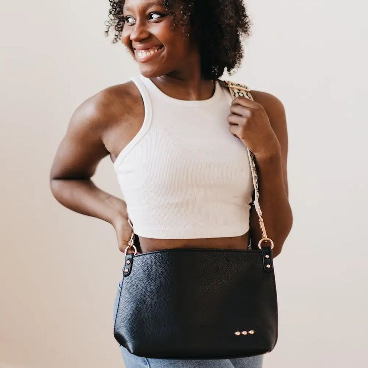 Make a statement with the Cora Structured Hobo Bag! This structured hobo-style bag features a guitar strap and snap closure for easy access, plus two handy zippers (one on the outside, one on the inside) for extra security. It also includes a small cloth pocket inside, so you can keep your goodies safe and organized. And with its flexible body, you can dress it up or down for any occasion! Versatile Shoulder Bag With Snap Closure For On-the-go, On-the-go Hobo Bag With Metal Hardware, Everyday Hobo Shoulder Bag With Metal Hardware, Crossbody Hobo Bag With Metal Hardware For Daily Use, Everyday Use Rectangular Hobo Bag With Metal Hardware, Rectangular Hobo Bag With Metal Hardware For Everyday, Everyday Hobo Tote Bag With Metal Hardware, Versatile Satchel With Snap Closure, Everyday Satchel Shoulder Bag With Gunmetal Hardware