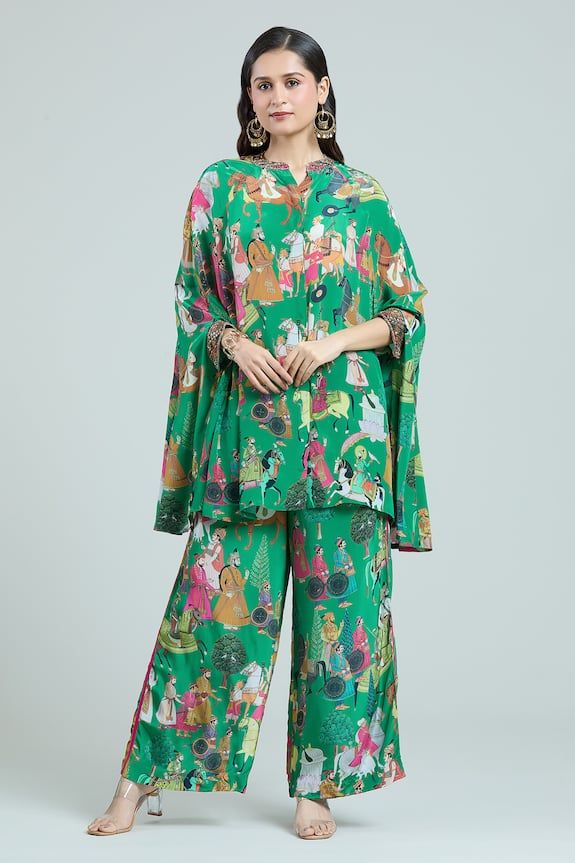 Lush green kaftan top with multi colored Mughal art inspired figurine prints, hand embroidered collar and cuffs. Comes with coordinating printed pant. - Aza Fashions Festive Green Silk Pant Set, Bohemian Designer Green Sets, Green Kimono Sleeve Sets For Spring, Green Sets With Kimono Sleeves For Spring, Spring Green Sets With Kimono Sleeves, Festive Green Printed Kaftan, Green Silk Long Sleeve Palazzo Set, Festive Green Printed Set, Traditional Green Palazzo Set With Digital Print