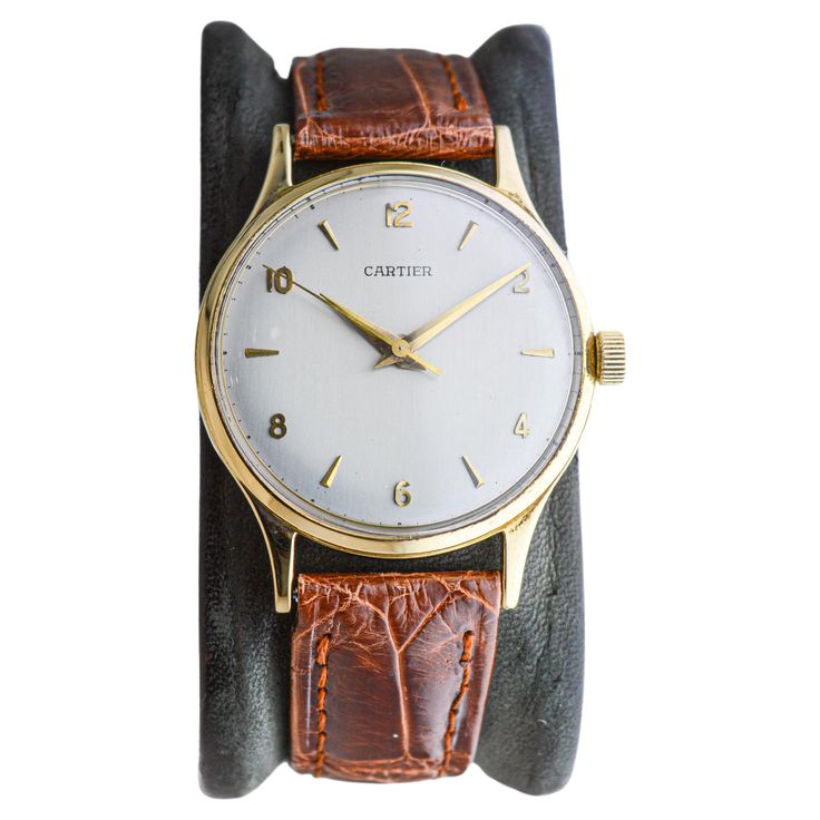 FACTORY / HOUSE: European Watch & Clock Co / Cartier Paris STYLE / REFERENCE: Calatrava Style METAL: 18Kt. Yellow Gold CIRCA: 1950's MOVEMENT / CALIBER: 17 Jewels / Sweep / European Watch & Clock Co. Caliber P800/C DIAL / HANDS: Silvered Dial with Arabic Numbers 18Kt. Gold Applied / Dauphine Hands DIMENSIONS: Length 41mm X Diameter 33mm ATTACHMENT / LENGTH: Leather, 16mm / Medium Length WARRANTY: 18 months on the movement. LIFETIME SERVICE COMMITMENT This is a rare watch with a screw back case. Jeanne Toussaint, Swiss Art, Factory House, Arabic Numbers, Watch Clock, Paris Style, Style Reference, Cartier Santos, Vacheron Constantin