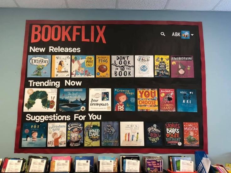 a bulletin board with books on it in front of a blue wall that says bookflix