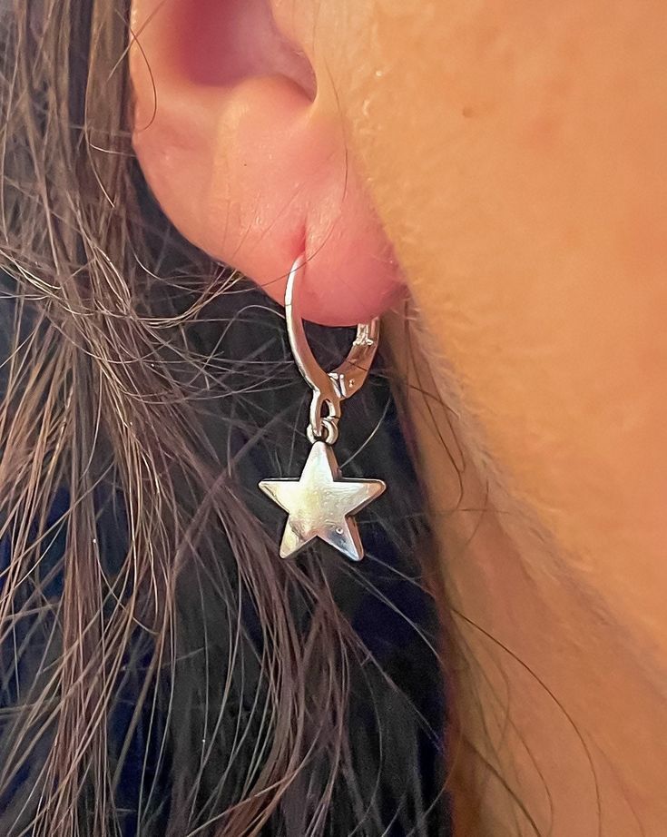 These tiny star huggies will quickly become your go-to earrings! Lightweight, yet durable and adorable. Wear them as a statement look or just add to your other favorite earrings to make a fun new look. Lever back to secure, these 'huggie' earrings are the perfect gift for someone or for yourself!  This listing is for one (1) pair of earrings.  Style:  ~ Silver Huggies: as pictured, silver plated ~ Sterling Silver: made to order, with 925 sterling silver hooks & hypoallergenic  ~ Stainless Steel: made to order, with stainless steel huggies (hoop style with lever back). 🔮Crystals for your collection & sharing with friends 🎁 Thank you for supporting our small business and unique healing creations. 🌞 FAST SAME-DAY USA SHIPPING! 💨💗 Orders over $50 get free shipping in the US & Free Tumbled Nickel-free Star-shaped Huggie Earrings, Everyday Drop Earrings With Star Charm, Adjustable Hoop Earrings With Star Charm, Sterling Silver Star Charm Huggie Earrings, Sterling Silver Star Charm Cartilage Earrings, Sterling Silver Star Cartilage Earrings With Star Charm, Hypoallergenic Star-shaped Cartilage Earrings For Everyday, Hypoallergenic Star-shaped Everyday Earrings, Hypoallergenic Star Earrings For Everyday