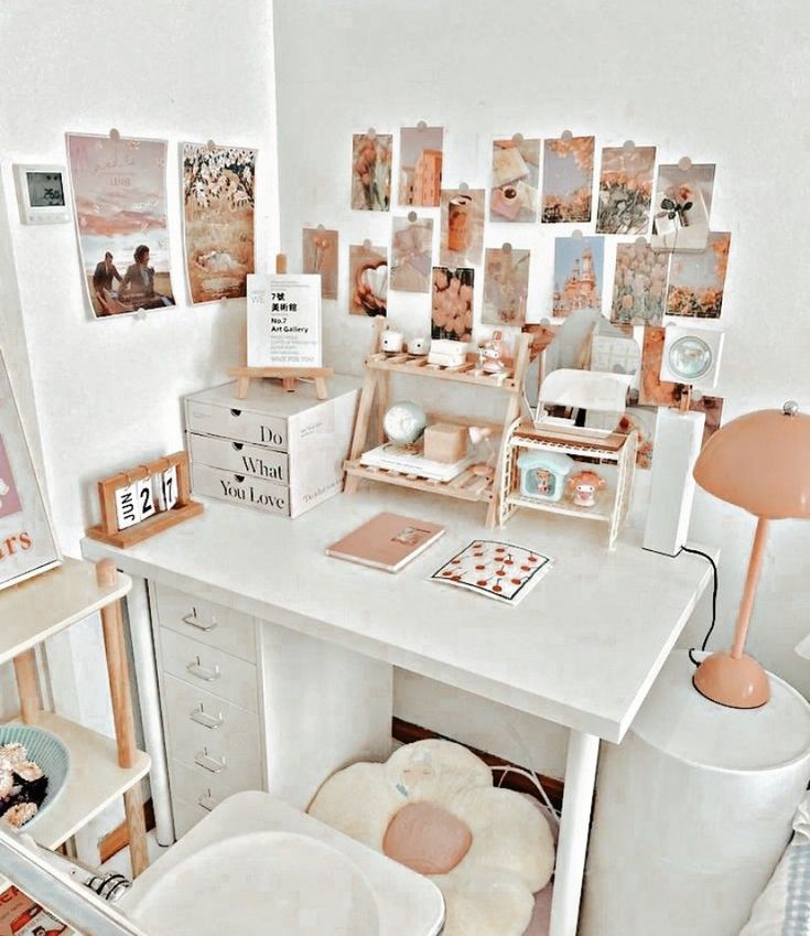 a white desk topped with lots of pictures