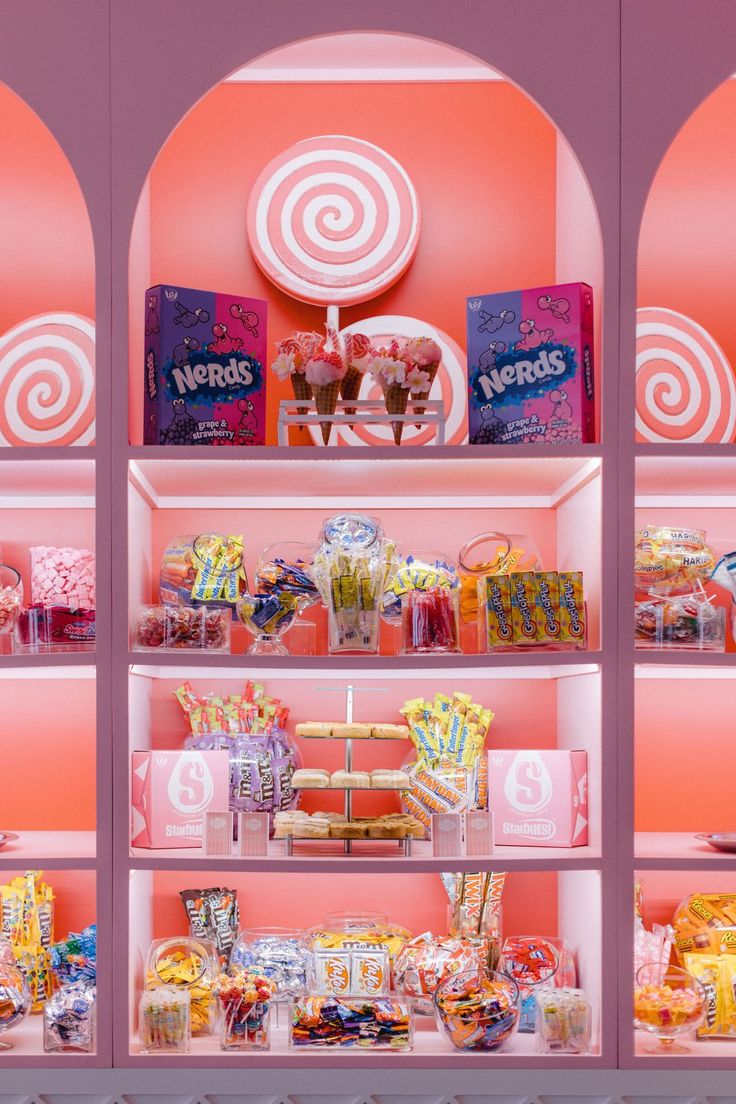 a candy store display case filled with lots of candies and lollipops