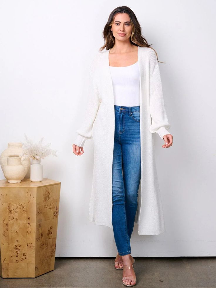 Looking for a cozy yet stylish addition to your wardrobe? Check out our Knitted Cardigan! With its comfortable long sleeves and open front design, this cardigan is perfect for layering. Add a touch of flair to any outfit with this versatile piece. * 89% Rayon 11% Nylon * Hand Wash * Color: White * Model is wearing size S | Length: 47" Bust: 36" Waist: 18" Winter White V-neck Outerwear For Layering, Cozy Open Front Cardigan For Layering, Trendy Soft Knit Sweater Coat For Layering, Winter White Long Sleeve Loungewear Cardigan, White Long Sleeve Cardigan For Loungewear, Chic Soft Knit Long Sleeve Cardigan, Chic Long Sleeve Soft Knit Cardigan, Solid Open Front Soft Knit Sweater Coat, Solid Soft Knit Sweater Coat With Open Front