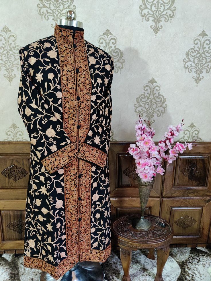 Get Customizable Kashmiri Jacket Wilh Aari Embroidery  A Long Woolen Kashmiri Jacket with All Over Aari Embroidery (Front & Back) This Kashmiri jacket Makes you stand apart with its vivid colours and Floral embroidery, The base colour is Black and Aari Embroidery is done all over the jacket, the material used is of high-quality Pure wool and the embroidery is done by brilliant Kashmiri artisans. Embroidery          :  Aari Work Length                 : 45 Inches (114.3cms)  [Customizable] Fabric Designer Embroidered Brocade Choli, Unstitched Jamawar Choli With Intricate Embroidery, Traditional Semi-stitched Nehru Jacket For Eid, Semi-stitched Embroidered Raw Silk Sherwani, Semi-stitched Raw Silk Sherwani With Embroidery, Festive Semi-stitched Sherwani With Floral Embroidery, Embroidered Long Sleeve Choli For Eid, Semi-stitched Chanderi Sherwani With Long Sleeves, Long Sleeve Embroidered Choli For Eid