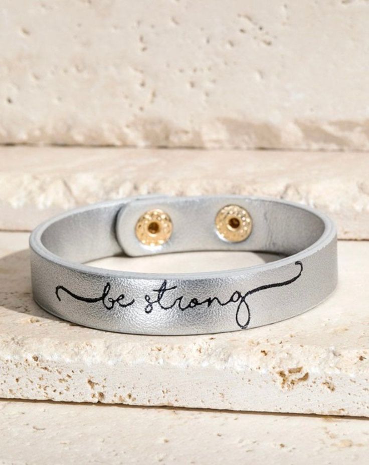 Be Strong Bracelet This adorable snap bracelet is so easy to put on and so stylish and fun to wear. We love that this one can be layered in all different colors and with our other fun leather snap bracelets! makes great gifts Adjustable Magnetic Bracelets For Everyday, Trendy Leather Bracelet As Gift, Trendy Leather Bracelet Gift, Fun Adjustable Nickel-free Bracelets, Adjustable Magnetic Jewelry For Everyday Wear, Silver Leather Bracelet With Hand Stamped Details For Everyday, Adjustable Magnetic Jewelry For Everyday, Trendy Letter Print Bracelets For Friendship, Trendy Letter Print Friendship Bracelets