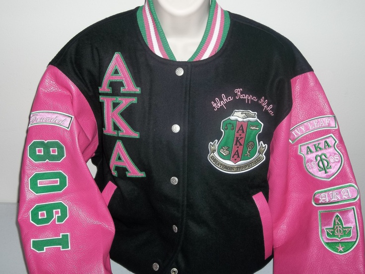 a pink and black jacket with green letters on it's sleeves that say akaka