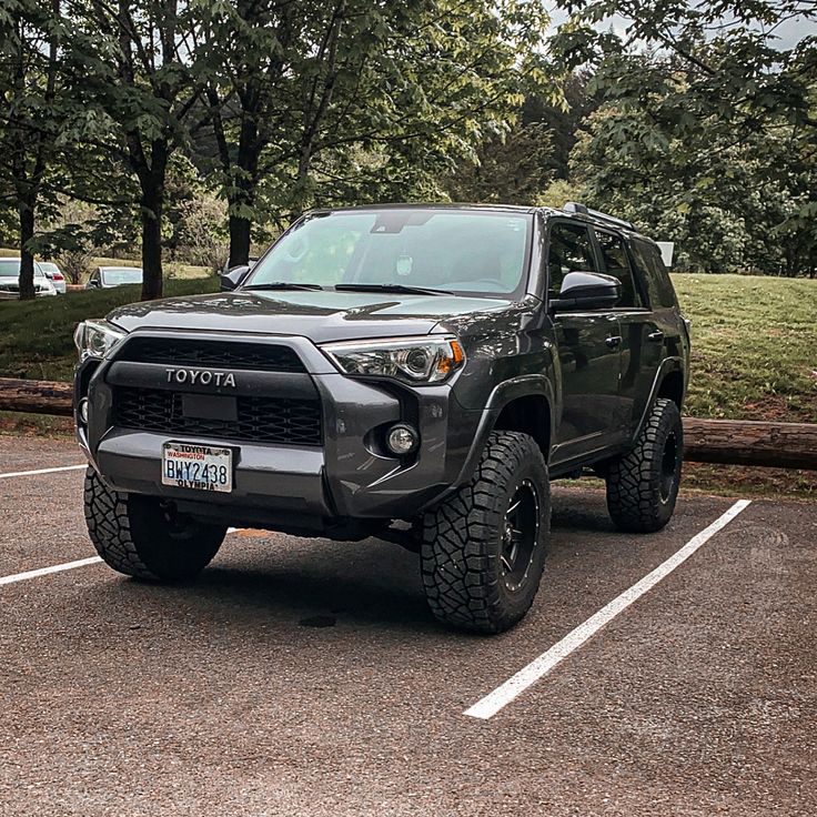 a black toyota truck parked in a parking lot