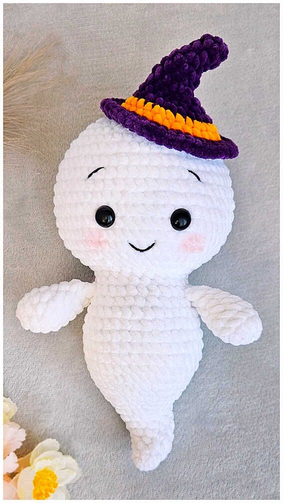 a white stuffed animal with a purple hat