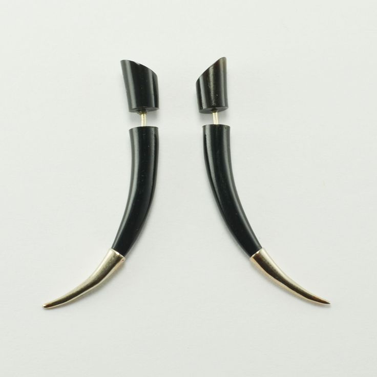 Sterling Silver Tipped Talon Earrings Faux - Gauges by Crown Republic | Hand Carved Earring Jewelry - Unique and Stylish Handmade Earrings These sleek pairs of medium talon earrings are sure to turn heads. Each talon earrings are hand carved from water buffalo horn and are tipped with sterling silver. The standard sized earring post separates the front and back of the earring to give you the appearance of having gauged piercings. All organic materials used to make our jewelry are responsibly sourced. Length: 50 mm *Made for regular pierced ears. *Sold in Pairs Claw Stud Earrings, Black Drag Earrings, Handmade Gothic Horned Jewelry, French Horn Earrings, Faux Gauges, Horn Earrings, Water Buffalo, Pierced Jewelry, Earring Post