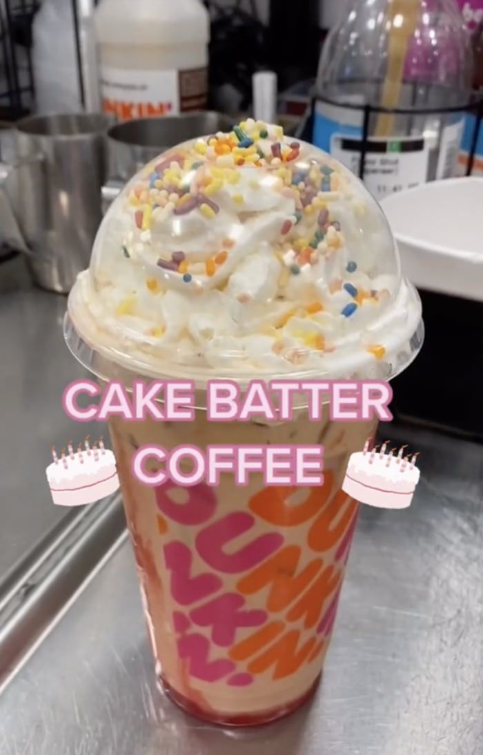 a cake batter coffee cup with sprinkles on top