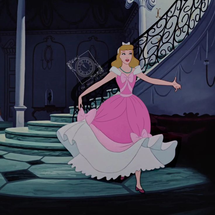 a woman in a pink dress is walking up some stairs