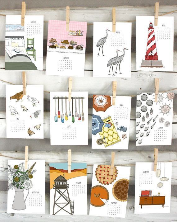 several calendars hanging on clothes pins with pictures of animals and lighthouses attached to them