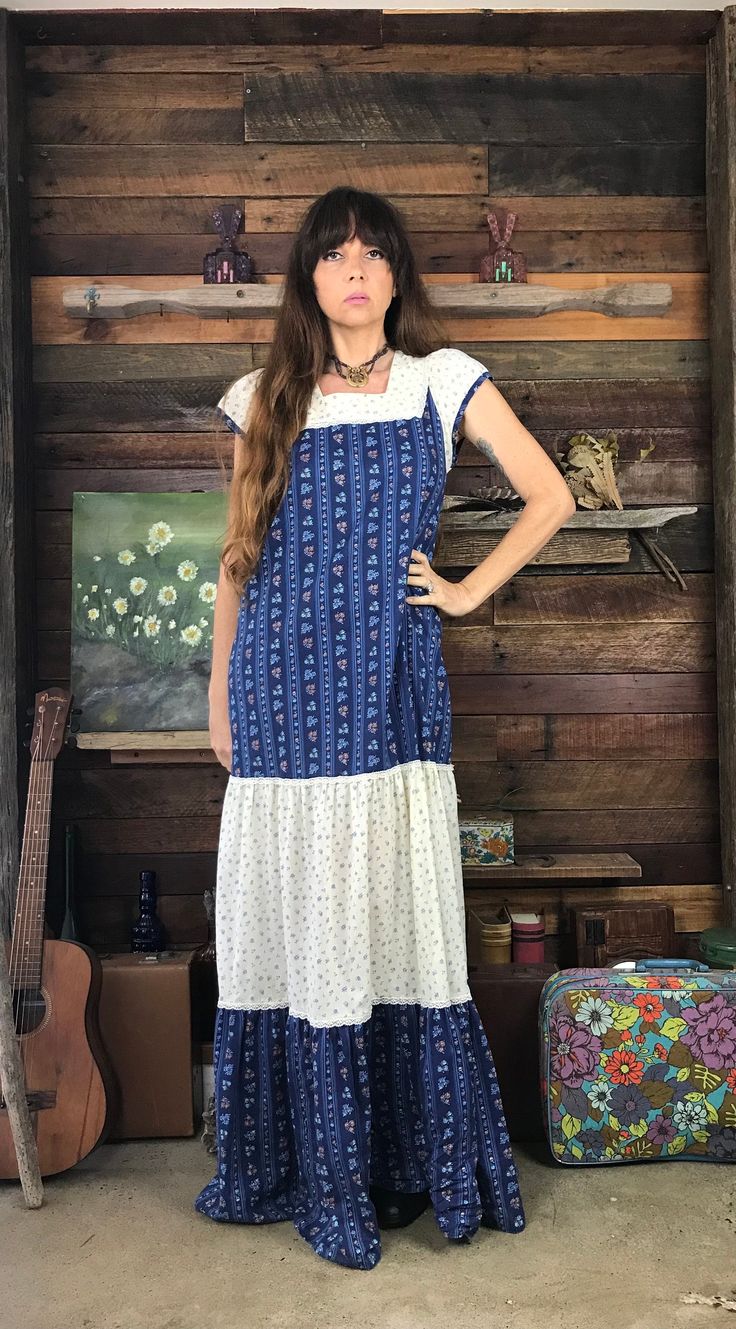 This pretty 1970's Prairie Maxi Dress features a square neckline and pretty puff capped sleeves.  It is made from soft blue and white floral fabric with a flowing, lace trimmed A line ankle length skirt.  It is in good vintage condition. Measurements: Length:  58.5" or 148cm Bust:  up to:  38" or 96cm Waist:  up to:  41" or 104cm Hips:  up to:  45" or 114cm Sleeve:  5" or 12.5cm All items are sold in laundered good or very good vintage condition.  Please check measurements and photos carefully and contact me with any questions. White Floral Fabric, Ankle Length Skirt, Blue And White Floral, Capped Sleeves, Square Necklines, Floral Fabric, Dress Clothes For Women, Square Neckline, Ankle Length