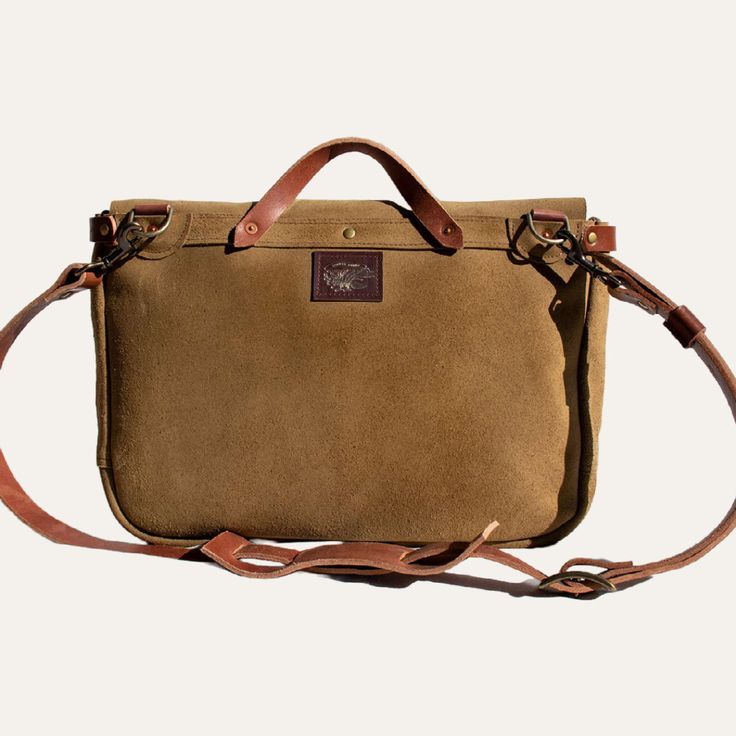 What you'll love about it: A messenger bag inspired by the days of old. The Tracker Messenger fits your laptop, notebooks, and is perfect for everyday use. The bag will wear with you and build character over time. Made with soft durable leather in coyote tan. How to style: A bag built for everyday use. This timeless piece pairs well with elevated casuals like denim and blazers. Details: -adjustable shoulder straps -unlined - 1 large outside pocket - 1 small inside pocket - laptop pocket - 3 pen Classic Waxed Canvas Laptop Bag For Everyday, Waxed Finish Satchel Laptop Bag For Daily Use, Classic Everyday Waxed Canvas Laptop Bag, Everyday Brown Laptop Bag With Waxed Finish, Waxed Canvas Briefcase With Luggage Sleeve, Brown Waxed Finish Laptop Bag, Classic Waxed Canvas Laptop Bag For Daily Use, Classic Waxed Canvas Satchel For Everyday Use, Rugged Satchel Laptop Bag For Everyday Use