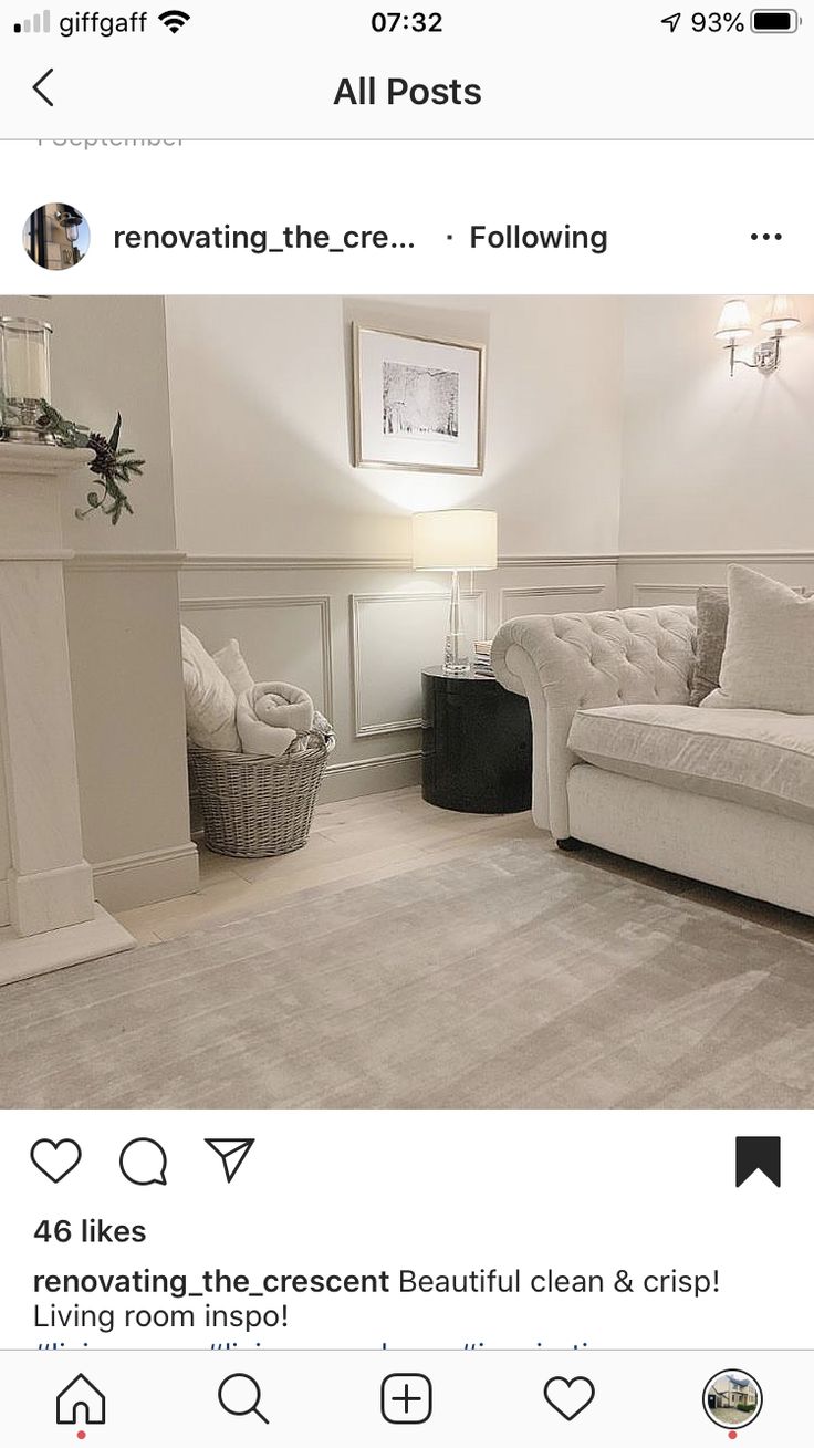 an instagram page with a white couch and fireplace in the corner, on top of a gray rug