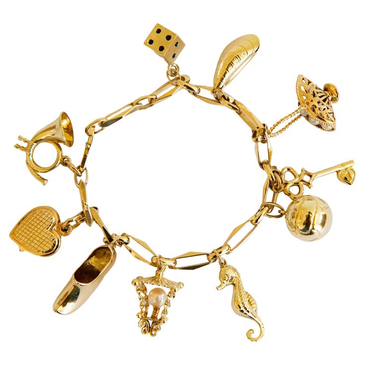 A vintage 14 karat yellow gold bracelet with 10 charms, including a hunting horn, a heart, a clog, a lantern, a seahorse, a ball, a key, a basket with five pearls, a mussel, and a dice. The bracelet was manufactured in the middle of the 20th century. Despite its age, it is in a really good condition. Please notice that the hunting horn charm has a small dent. The bracelet is absolutely a cheerful and playful eye catcher. It can be worn during daily as well as special occasions. The bracelet is the most suitable for a person with a middle- and a wider wrist. The bracelet as well as each charm were tested and are marked with the 14 karat gold marks. Measurements: length: 19 cm, width: 5 mm charms: ca. 8-35 mm weight: 29.8 grams Luxury Tarnish-resistant Metal Charm Bracelet, Classic Luxury Gold Charm Bracelet, Cheap Gold Charm Bracelet With Removable Charms, Luxury Vintage Charm Bracelet As A Gift, Cheap Vintage Gold Charm Bracelet, Vintage Gold Charm Bracelet Luxury, Cheap Bohemian Charm Bracelets With Lobster Clasp, Antique Charm Bracelet, Yellow Bracelet