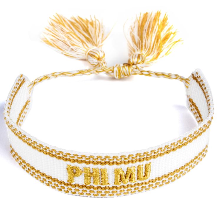 a white and gold bracelet with the word pmm on it