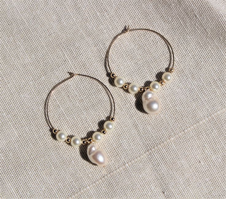 "\" MAMA'S PEARLS \" These vintage inspired beautiful pearl hoops are the perfect addition to your summer wardrobe. Layer them with other hoops or wear them alone! You will never want to take them off! L E T S . T A L K . E A R R I N G S ✤ Available in Sterling Silver and 14k Gold Filled. ✤ Swarovski pearl ✤ Tarnish resistant ✤ Safe for sensitive skin ✤ Available in one size - From the ear lobe Approx 1 3/4\" or 40mm ✤ Comes as a pair All purchased items will arrive in a Tommassini Jewelry box, Handmade Pearl Hoop Earrings For Weddings, Adjustable Hoop Earrings With Pearl Charm As Gift, Adjustable Hoop Pearl Drop Earrings, Handmade Hoop Pearl Earrings For Anniversary, Handmade Pearl Hoop Earrings For Anniversary, Beaded Hoop Earrings For Wedding, Pearl Hoop Earrings Wire Wrapped For Gift, Pearl Wire-wrapped Hoop Earrings As Gift, Pearl Wire Wrapped Hoop Earrings As Gift