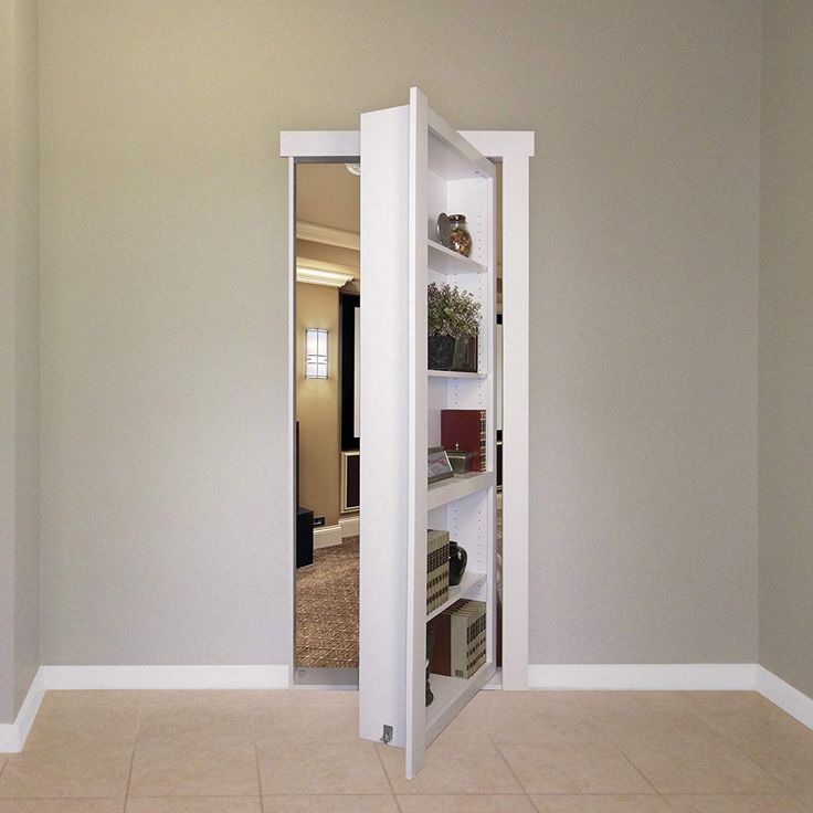 an open door in the middle of a room with white walls and tile flooring