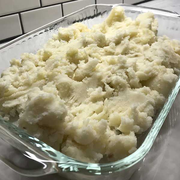 a casserole dish filled with mashed potatoes