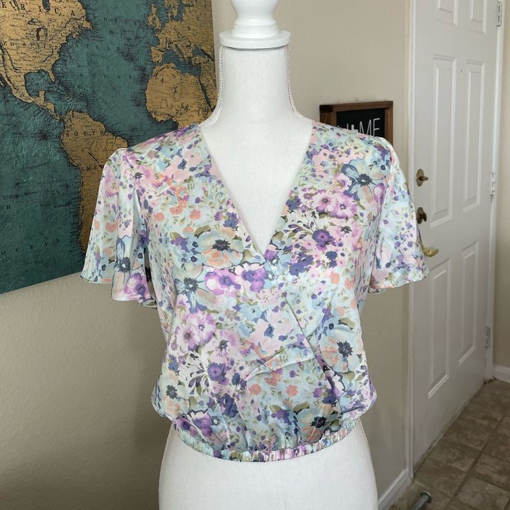 Astr Blue Floral Blouse Nwot So No Flaws, Damage And Never Worn Before. Features A Beautiful Butterfly Neck And A Faux Wrap. Flowers Are Purple, Blue And Some Orange/Pink Color. These Pictures Don’t Give Them Justice. Offers Welcome :) Size Extra Small 100% Polyester Dry Clean Only Feminine Fitted Multicolor Tops, Fitted Feminine Multicolor Tops, Multicolor Crop Top Blouse For Spring, Multicolor Cropped Floral Print Blouse, Multicolor Cropped Floral Blouse, Multicolor Cropped Blouse For Spring, Wrap Flowers, Orange Pink Color, Blue Floral Blouse