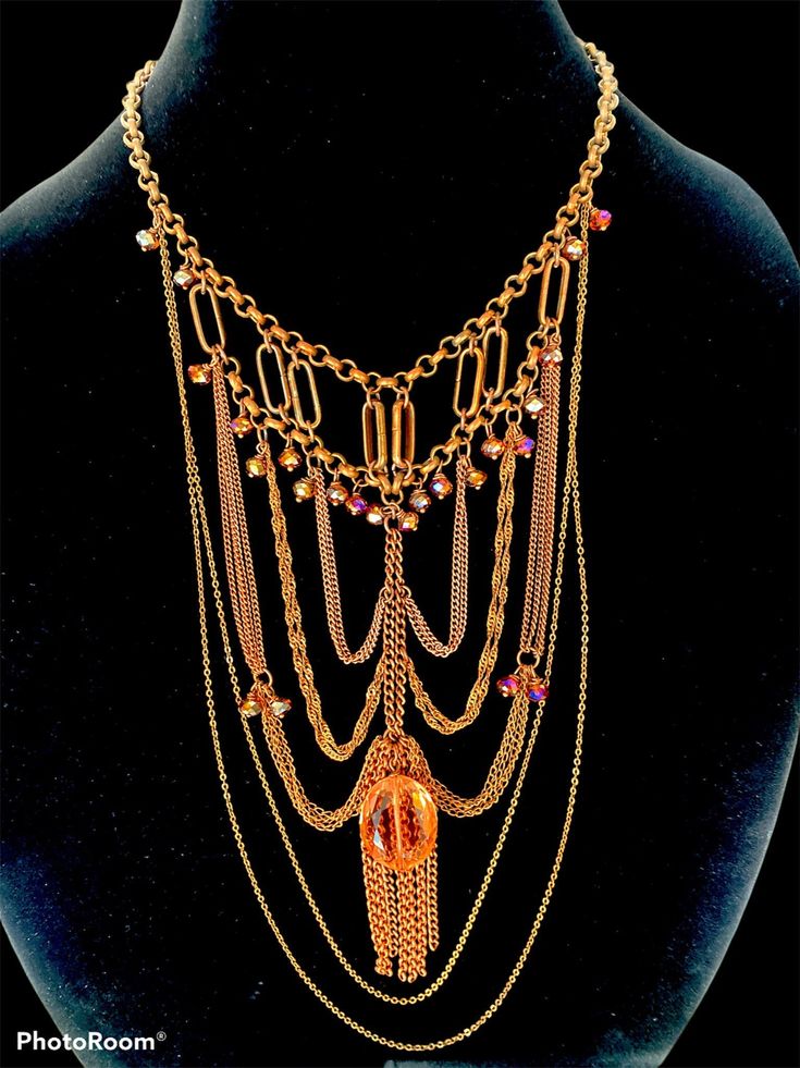 This necklace is hand made.  Worn around the neck it hands feel into the chest line. The prism catches the light beautifully. Decorated in Rose, amber and champagne colored beads. This necklace looks luxurious. Glamorous Gold Beaded Necklaces, Bohemian Rose Gold Jewelry For Party, Unique Multi-strand Necklace For Parties, Gold Multi-strand Crystal Party Necklaces, Bohemian Gold Crystal Necklace, Gold Bohemian Crystal Necklace For Party, Gold Multi-strand Crystal Party Necklace, Gold Multi-strand Crystal Necklace For Party, Multi-strand Gold Necklaces For Celebrations