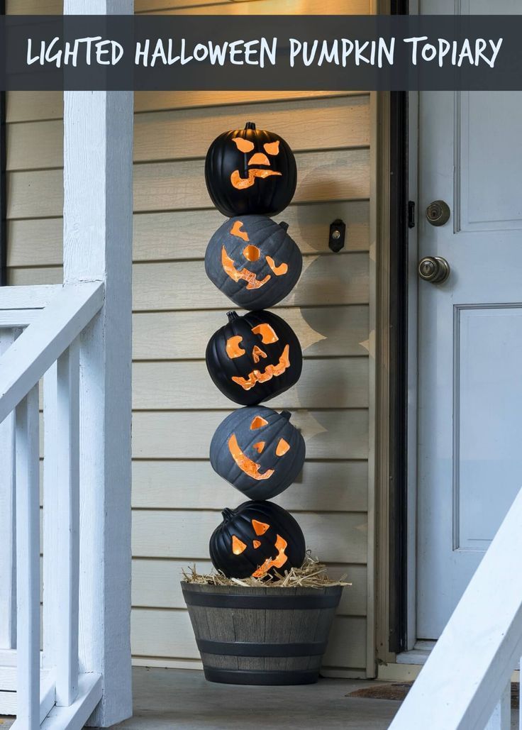 three pumpkins are stacked on top of each other in front of a house with the words, lighted halloween pumpkin topiary