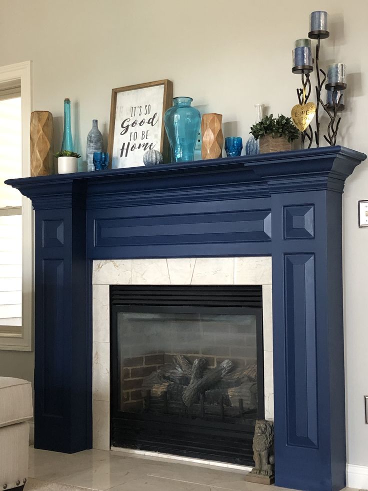 a living room with a fireplace and blue mantle