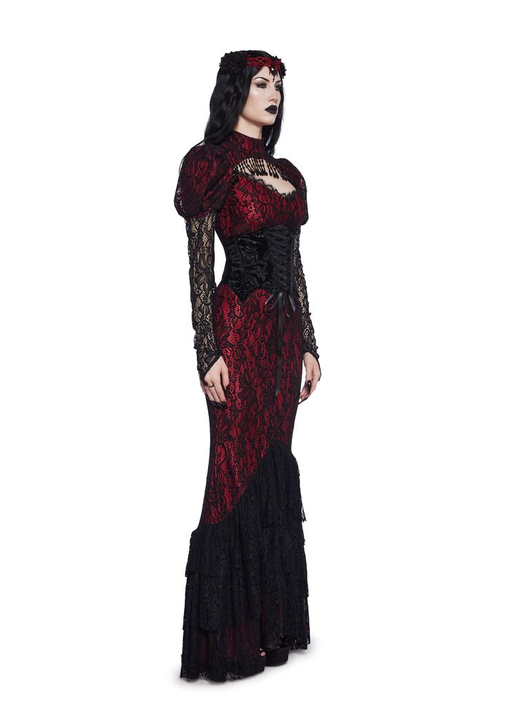 Rule Halloween night with this costume set that includes a maxi dress that is fully lined, has a lace overlay, a high neckline, a cut out design with a beaded trim, puffy sleeves, attached sheer lace long sleeves with loop straps, a layered mermaid style skirt, a back zip closure, a crushed velvet waist cincher with structured boning, intricate designs, satin ribbon lace-ups, and a side zipper closure. Also comes with a barrette headband with a brooch gemstone in the center and a pair of fangs. Vampire Dress Costume, Vampire Women’s Costume, Dark Red Gothic Dress, Vampire Gothic Outfits, Womens Vampire Costume Diy, Vampire Costume Ideas Women, Women Vampire Costume, Vampire Clothing, Daughter Of Darkness