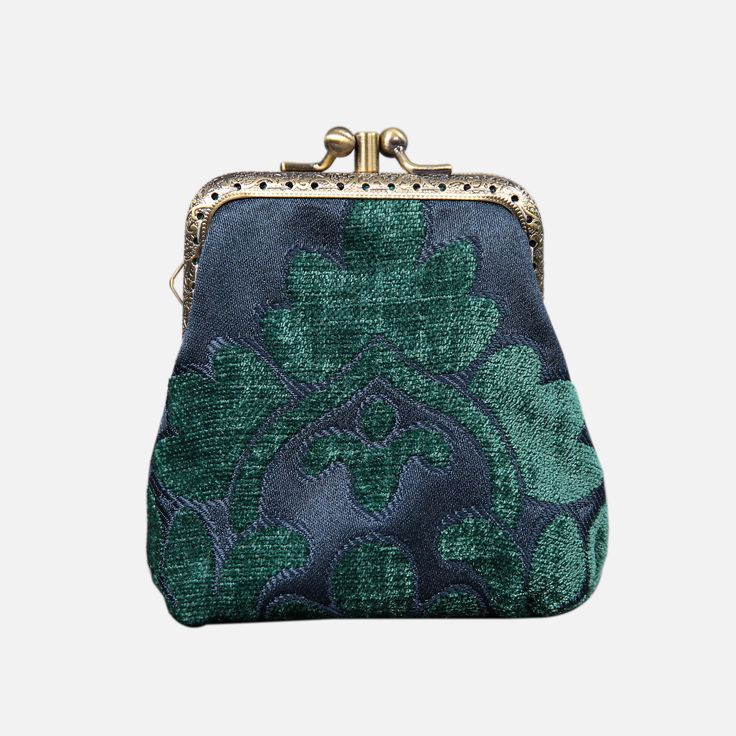 Discover the perfect blend of elegance and functionality with this chic coin purse. Lovingly crafted from rich Chenille Carpet and adorned with a delightful cotton floral canvas, this vintage-style wallet exudes timeless charm. The brass clasp, featuring a double kiss lock, adds a touch of sophistication to this accessory. Effortlessly secure your belongings while showcasing your impeccable taste. Designed with convenience in mind, this coin purse boasts pockets on both sides of the middle panel Formal Wallet With Coin Pocket, Elegant Everyday Pouch With Coin Pocket, Chic Compact Coin Purse For Daily Use, Elegant Green Wallet For Formal Occasions, Green Elegant Formal Wallets, Elegant Green Formal Wallet, Classic Pouch Coin Purse, Classic Clutch Coin Purse For Gift, Vintage Green Formal Clutch