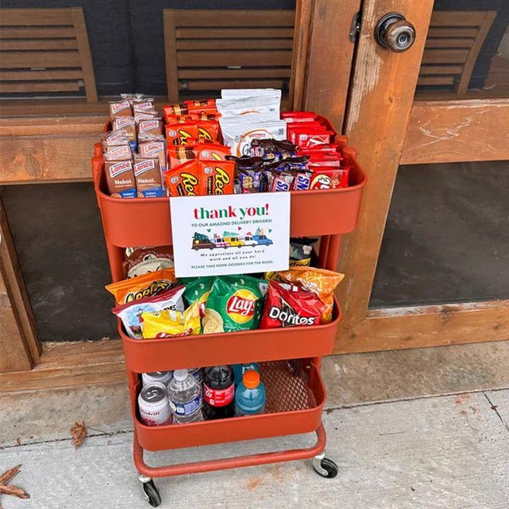 a red cart filled with lots of food next to a door