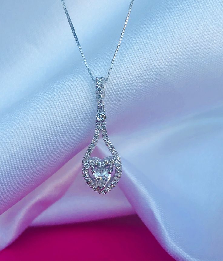 14K white gold necklace with .39CTW diamonds. 4.50x4.20mm heart shape center diamond with round halo around it. Approx. 24x8.46mm pendant dimensions with the bail. 18" box chain with lobster clasp Heart-shaped Diamond Halo Jewelry, Sterling Silver Jewelry With Halo Design For Valentine's Day, Sterling Silver Halo Jewelry For Valentine's Day, Silver Heart Cut Jewelry With Halo Design, Silver Jewelry With Heart Cut Halo Design, Valentine's Day Halo Cubic Zirconia Jewelry, Valentine's Day Cubic Zirconia Halo Jewelry, Valentine's Day Sterling Silver Jewelry With Halo Design, Valentine's Day Diamond Halo Jewelry