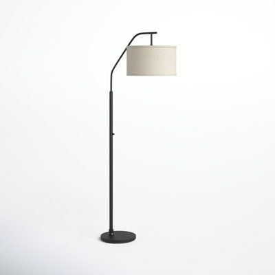 a black floor lamp with a white shade