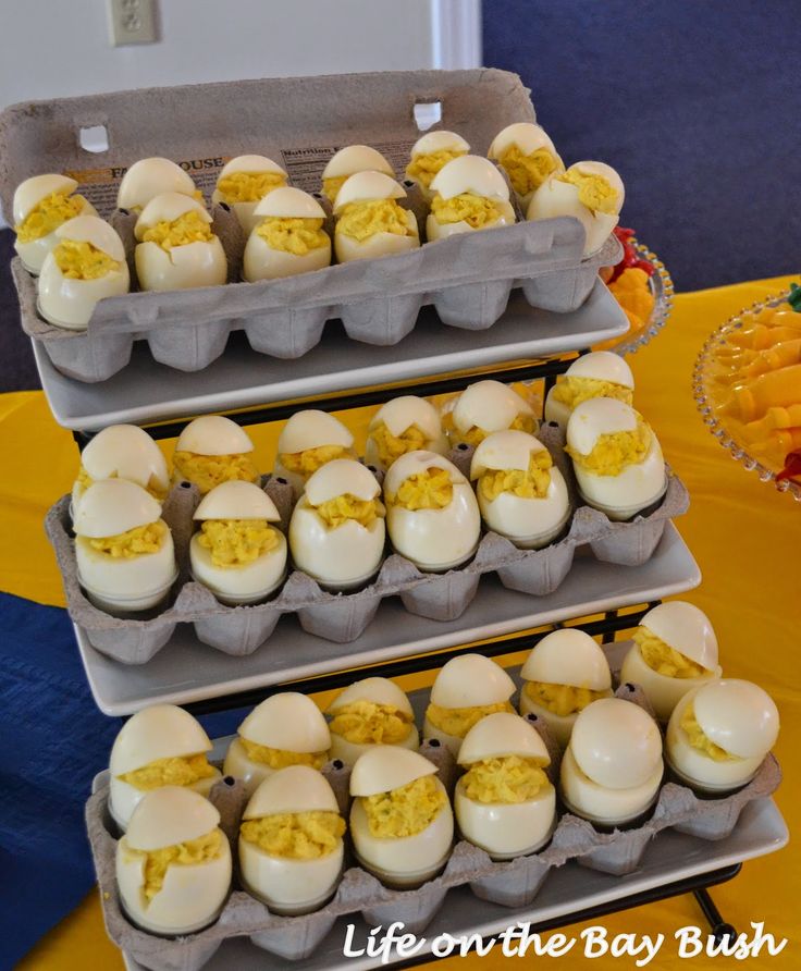 three trays filled with eggs sitting on top of a table next to each other