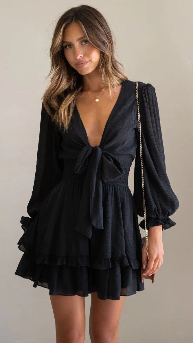 Details: Plunging V neckline Mini dress Front bowtie design Long sleeves Size and Fit: Size Length Bust S 72cm/28.3'' 83cm/32'' M 73cm/28.7'' 87cm/34.2'' L 74cm/29.1'' 93cm/36.6'' XL 79cm/29.5'' 97cm/38.2'' Tiered Ruffle Skirt, Feminine Design, Ruffle Skirt, Types Of Dresses, Balloon Sleeves, Mini Dress With Sleeves, Xl Dress, Black Long Sleeve, Women's Dresses