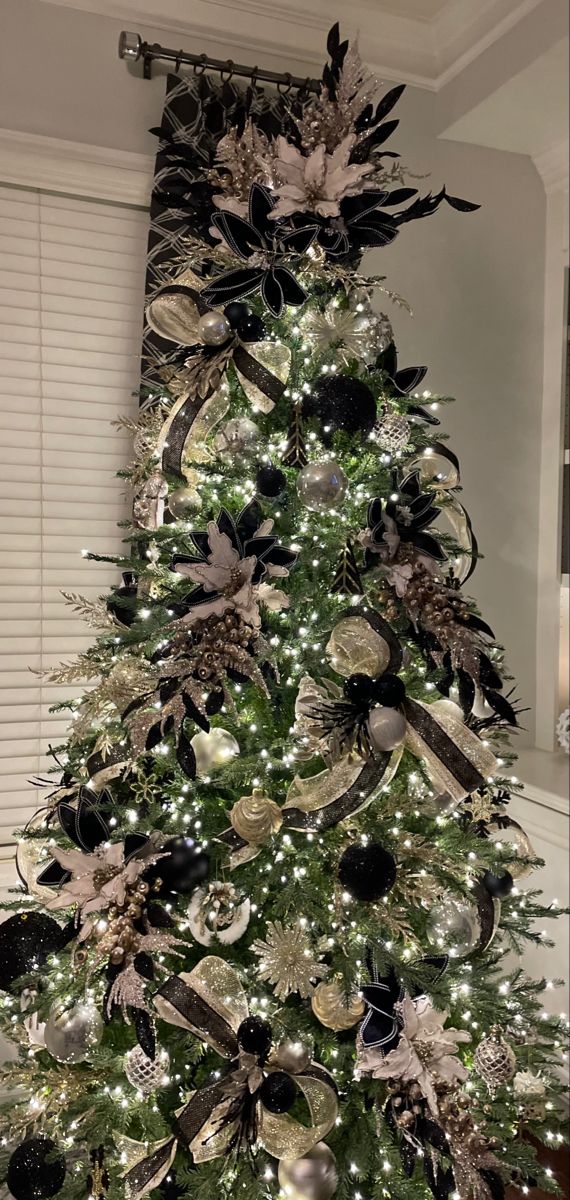 a christmas tree decorated with black and silver ornaments