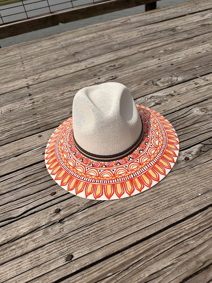 Don't miss your opportunity to own this one of a kind hand painted hat. The detailing is impressive. Perfect for a day at the beach, a sporting good outing or everyday use. Perfect for adding an extra special touch to your outfit. Size is Large Orange Fedora Hat For Beach, Orange Fedora Hat For The Beach, Orange Fedora For Beach, White Fedora Panama Hat For Festivals, Adjustable Hand Painted Brimmed Sun Hat, Adjustable White Panama Hat For Festivals, Adjustable White Panama Hat For Festival, Artisan White Sun Hat For The Beach, Artisan Multicolor Fedora For Beach