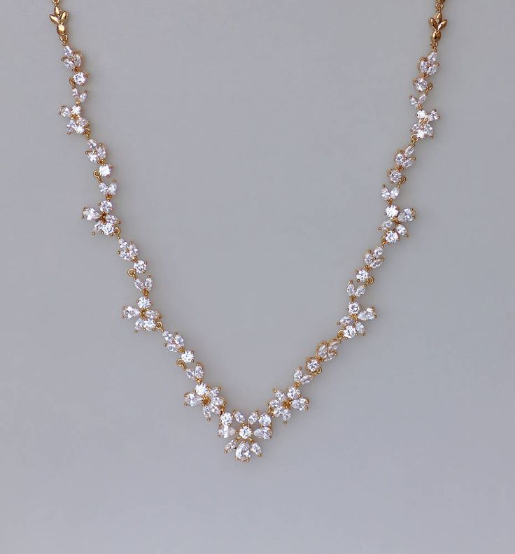 "Marquise cut crystals in a graceful leaf design create the most stunning bridal necklace, with gorgeous sparkle. We have designed this beautiful gold necklace to enhance your décolletage for an elegant and very sophisticated touch to your wedding day jewels. Measures: L = 16.5\" (42 cm) 2\" extender chain is available-see drop menu. 💟 Items that coordinate or are frequently bought together: (some are pictured above) https://www.etsy.com/listing/264959113 https://www.etsy.com/listing/265196688 Elegant Rose Gold Crystal Necklace For Wedding, Dainty Gold Rhinestone Necklace For Wedding, Dainty Gold Rhinestone Wedding Necklace, Gold Crystal Backdrop Necklace For Formal Occasions, Formal Gold Crystal Backdrop Necklace, Elegant Gold Rhinestone Necklace For Wedding, Dainty Gold Cubic Zirconia Bridal Necklace, Gold Crystal Bridal Necklace With Elegant Design, Dazzling Gold Bridal Necklace With Crystals