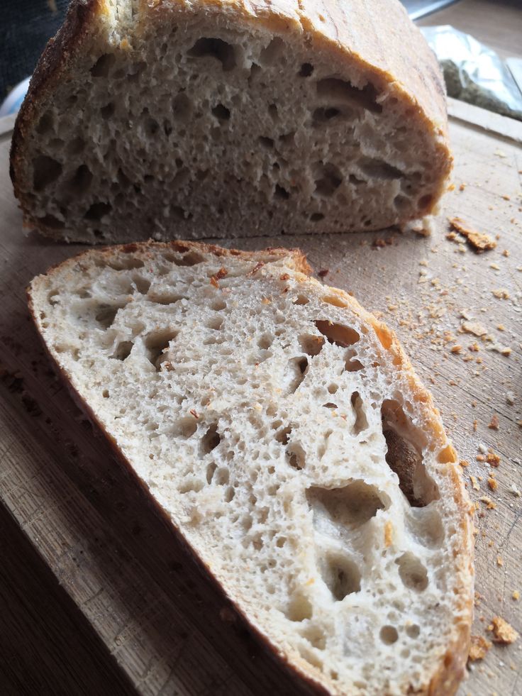 a loaf of bread sitting on top of a wooden cutting board